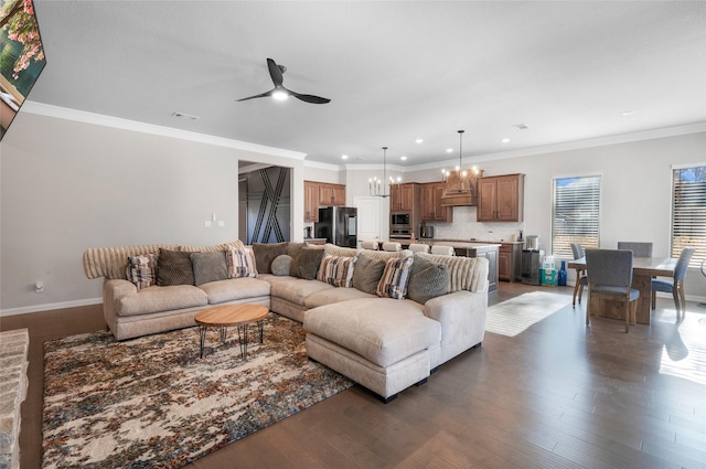 living room featuring crown molding, dark hardwood / wood-style flooring, and ceiling fan with notable chandelier