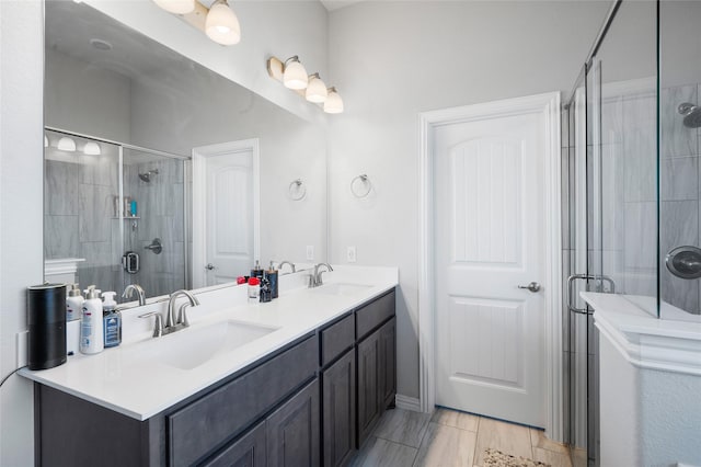 bathroom with vanity and a shower with shower door