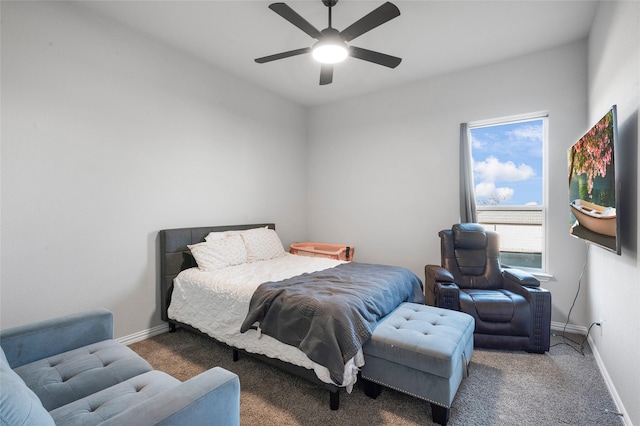 bedroom featuring ceiling fan and dark carpet