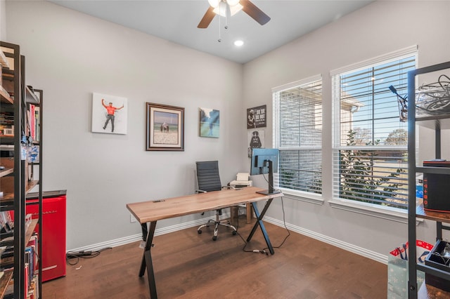 home office with dark hardwood / wood-style flooring and ceiling fan