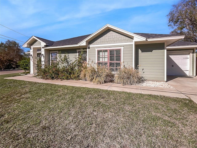 single story home featuring a garage and a front lawn