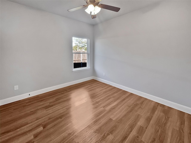 empty room with ceiling fan and wood-type flooring