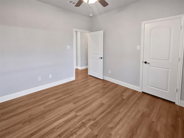 spare room with hardwood / wood-style flooring and ceiling fan