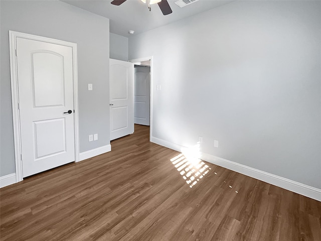 unfurnished bedroom with ceiling fan and dark hardwood / wood-style flooring