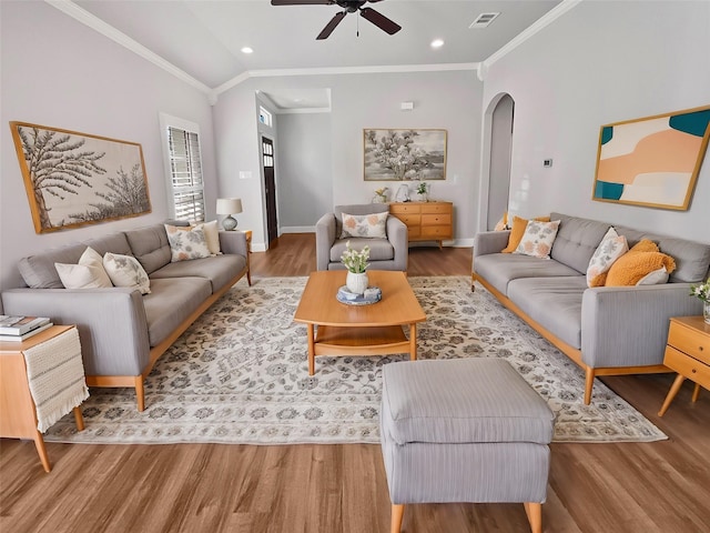 living room with hardwood / wood-style floors, ceiling fan, and ornamental molding