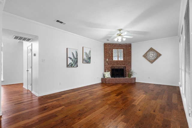 unfurnished living room with a brick fireplace, visible vents, hardwood / wood-style floors, and ornamental molding