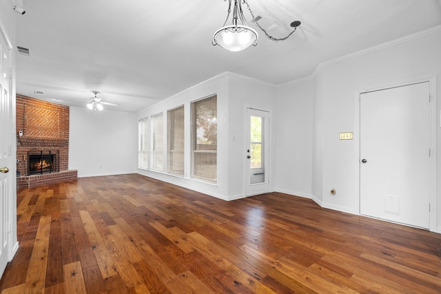 unfurnished living room with wood-type flooring, a fireplace, ornamental molding, and visible vents