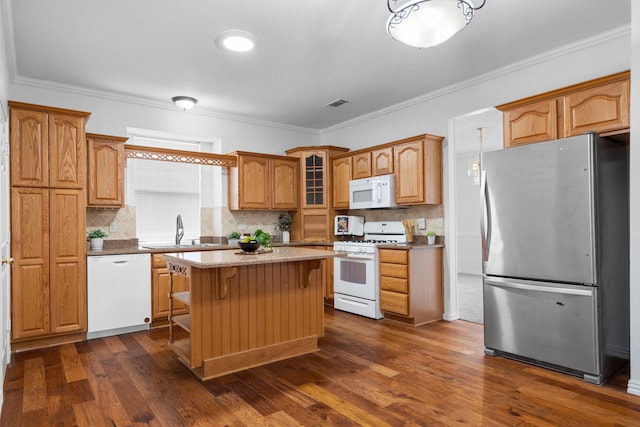 kitchen with crown molding, glass insert cabinets, dark wood-type flooring, a sink, and white appliances