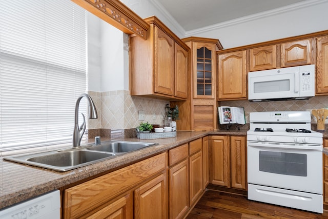 kitchen featuring backsplash, ornamental molding, dark wood-type flooring, a sink, and white appliances