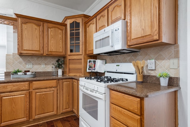 kitchen with white appliances, dark wood-style flooring, tasteful backsplash, glass insert cabinets, and crown molding