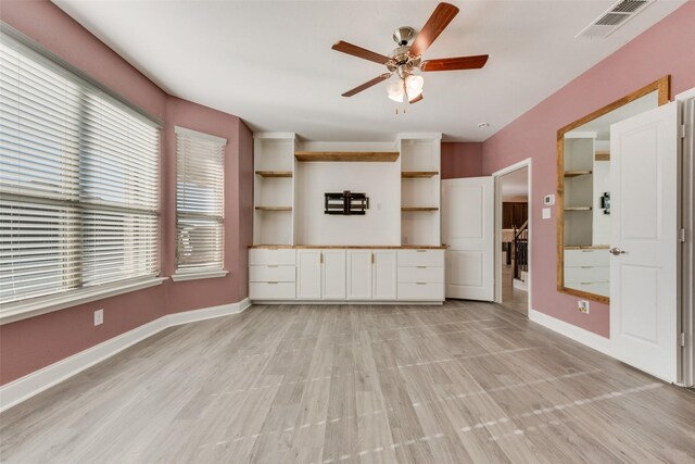 unfurnished living room featuring ceiling fan