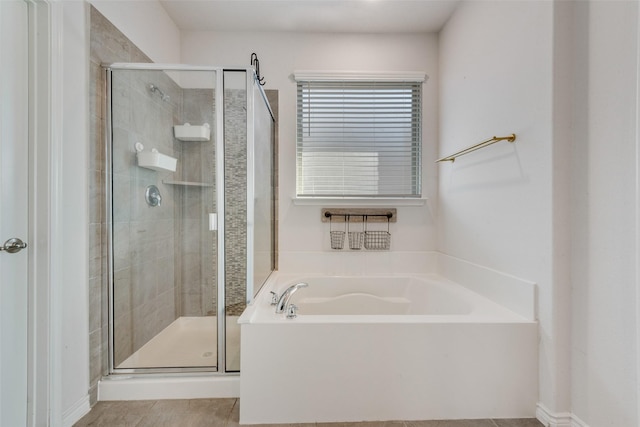 bathroom with separate shower and tub and tile patterned floors