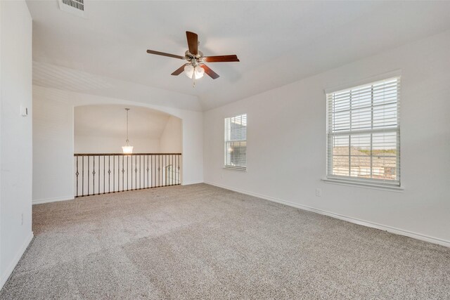 unfurnished room with carpet, vaulted ceiling, and ceiling fan