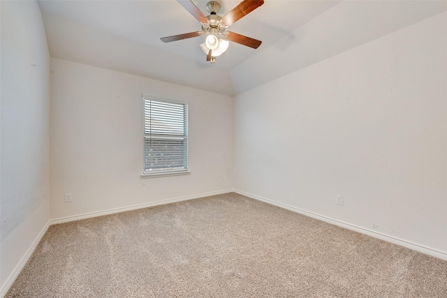 empty room with ceiling fan, carpet, and vaulted ceiling