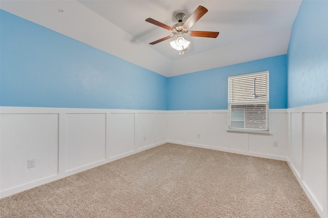 carpeted empty room featuring ceiling fan and lofted ceiling