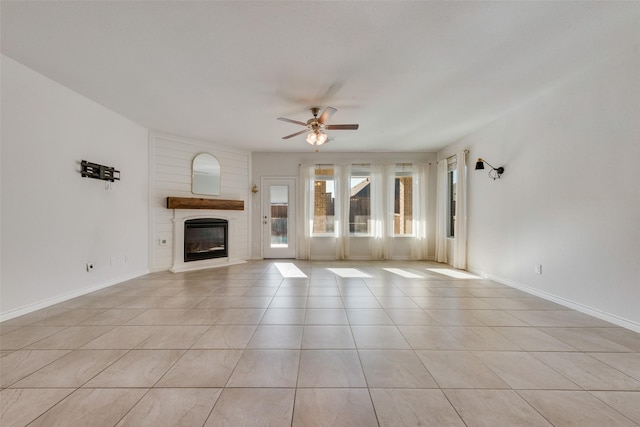 unfurnished living room featuring ceiling fan and light tile patterned floors