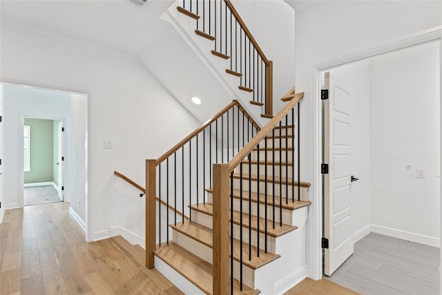 stairs featuring hardwood / wood-style floors