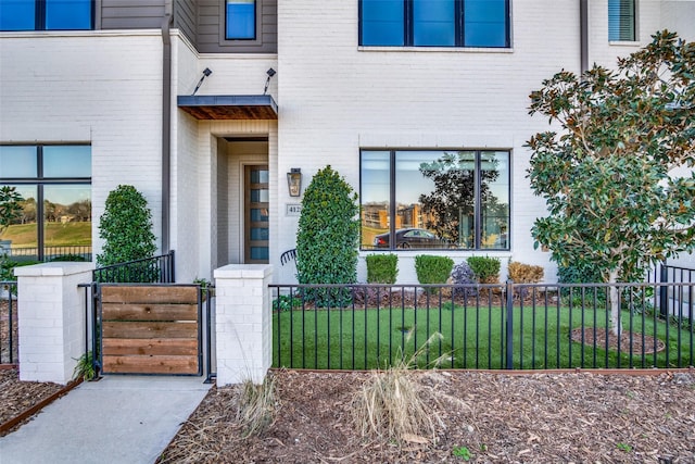 doorway to property with a lawn