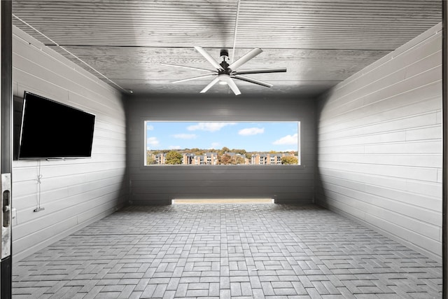 interior space with ceiling fan and wooden ceiling