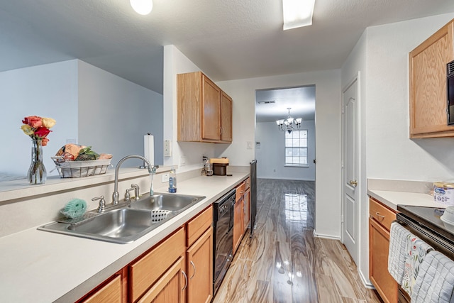 kitchen featuring black appliances, sink, light wood-type flooring, a textured ceiling, and a chandelier