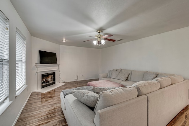 living room with wood-type flooring and ceiling fan