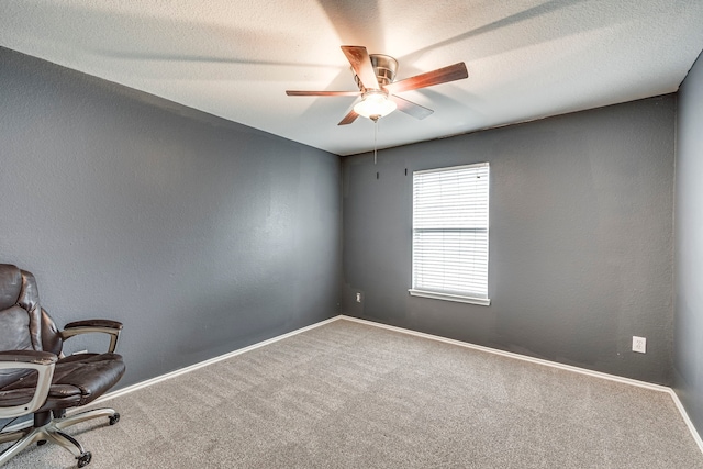 spare room with carpet flooring, a textured ceiling, and ceiling fan