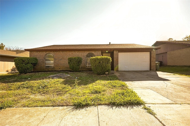 ranch-style home with a garage and a front lawn