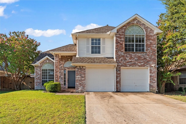 view of front of property with a front yard and a garage