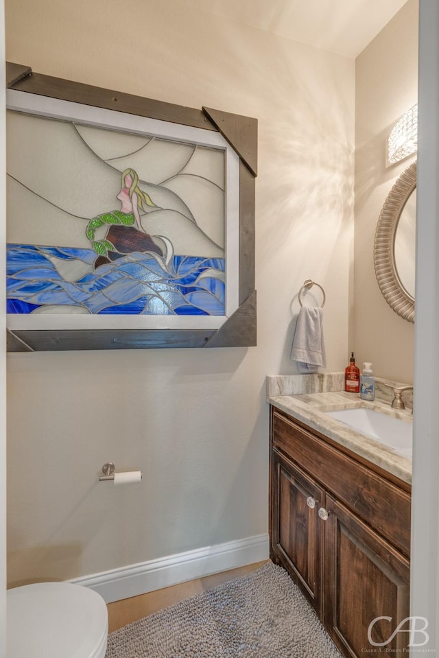 bathroom featuring tile patterned flooring, vanity, and toilet