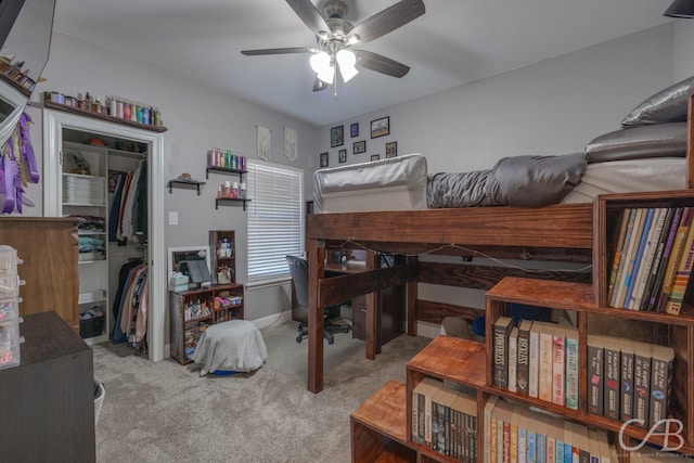 carpeted bedroom with ceiling fan and a closet