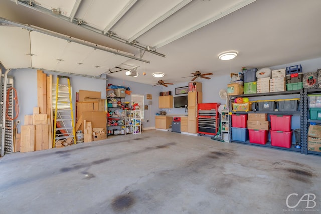 garage with ceiling fan and a garage door opener