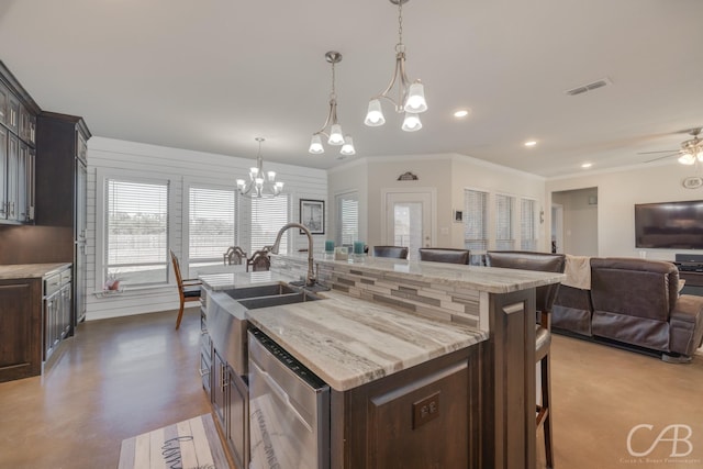 kitchen with a kitchen bar, a kitchen island with sink, dark brown cabinets, and dishwasher