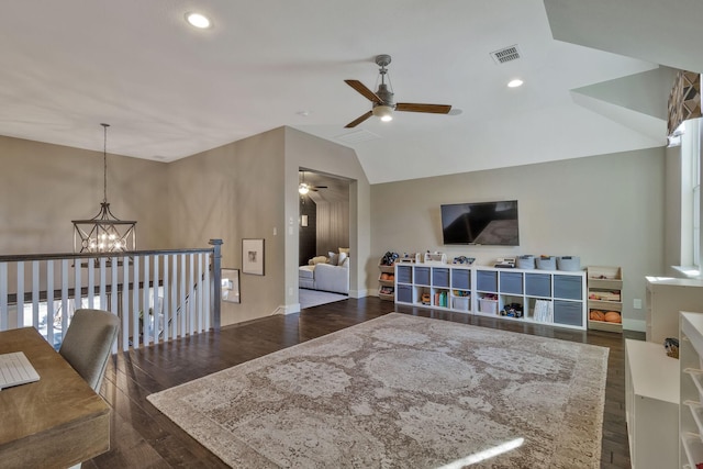 living room featuring dark hardwood / wood-style flooring, ceiling fan with notable chandelier, and lofted ceiling