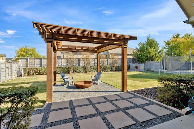 view of patio with a trampoline, a pergola, and an outdoor fire pit