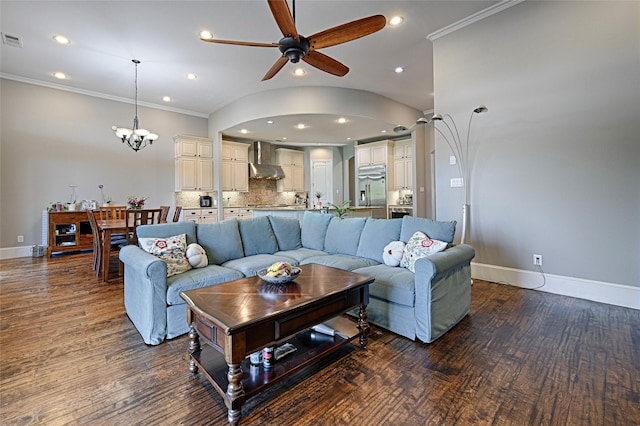 living room featuring ceiling fan with notable chandelier, dark hardwood / wood-style floors, and crown molding