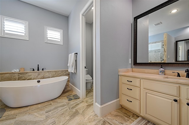 full bathroom featuring vanity, toilet, and independent shower and bath