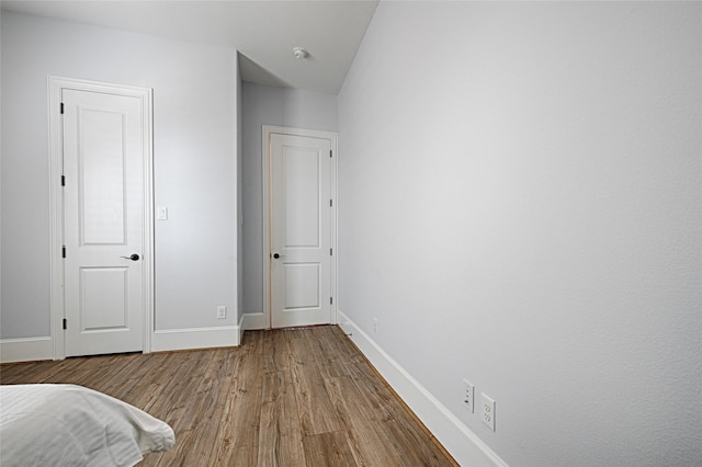 unfurnished bedroom with hardwood / wood-style floors