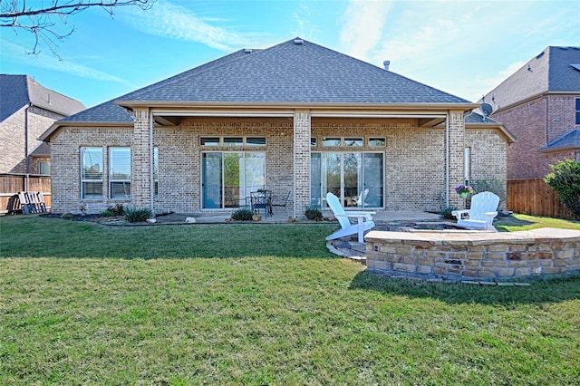 back of house with a yard and a patio