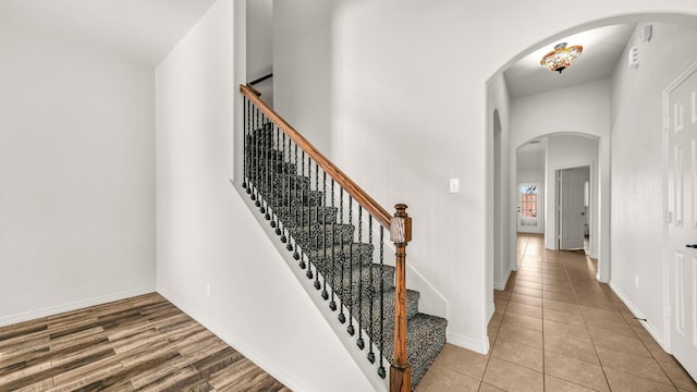 914 Randall Rd, Weatherford, TX 76087 - stairs featuring tile patterned flooring, baseboards, and arched walkways