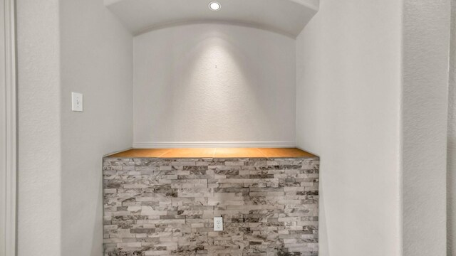 unfurnished living room featuring light tile patterned floors, recessed lighting, ceiling fan, a stone fireplace, and baseboards