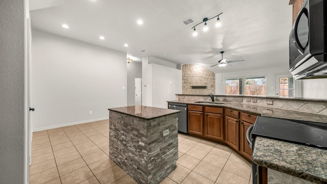 kitchen featuring visible vents, dishwashing machine, black microwave, a sink, and light tile patterned flooring