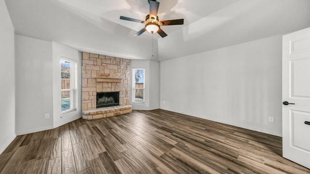 914 Randall Rd, Weatherford, TX 76087 - unfurnished living room featuring a stone fireplace, wood finished floors, baseboards, and ceiling fan