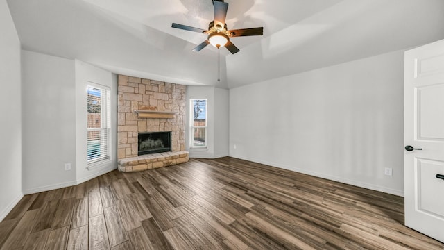 unfurnished living room featuring a stone fireplace, ceiling fan, and hardwood / wood-style flooring