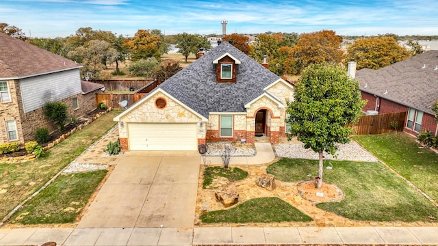 view of front of house with brick siding, concrete driveway, an attached garage, fence, and a front lawn