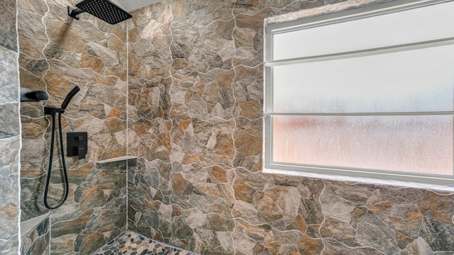 interior details featuring a tile shower