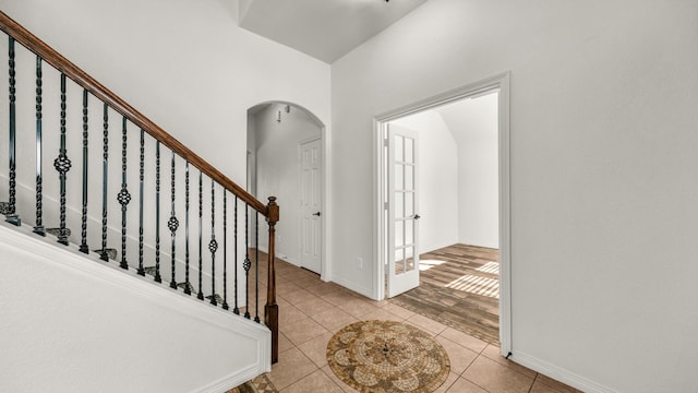 914 Randall Rd, Weatherford, TX 76087 - foyer entrance with arched walkways, stairs, baseboards, and light tile patterned flooring