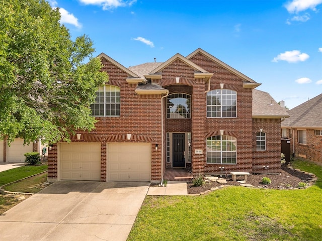 view of property with a front yard and a garage