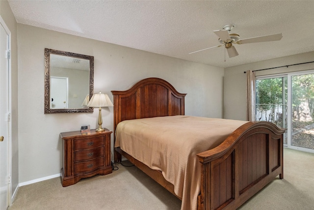 carpeted bedroom featuring access to exterior, a textured ceiling, and ceiling fan