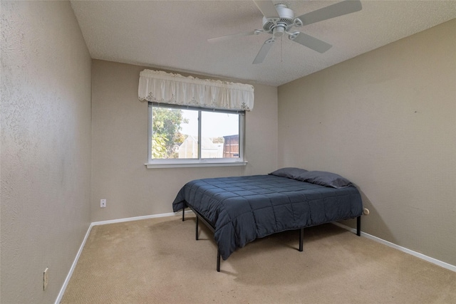 bedroom with light colored carpet and ceiling fan