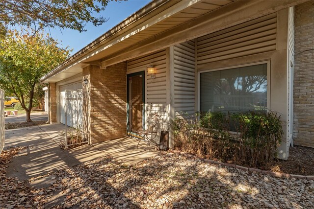 doorway to property with a garage